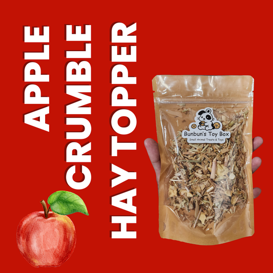 Packaged hay topper with 'Apple Crumble' text and a hand holding the package on a red background.